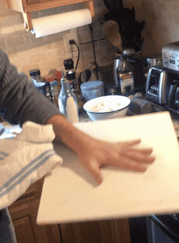 Author flipping a dish out of a skillet