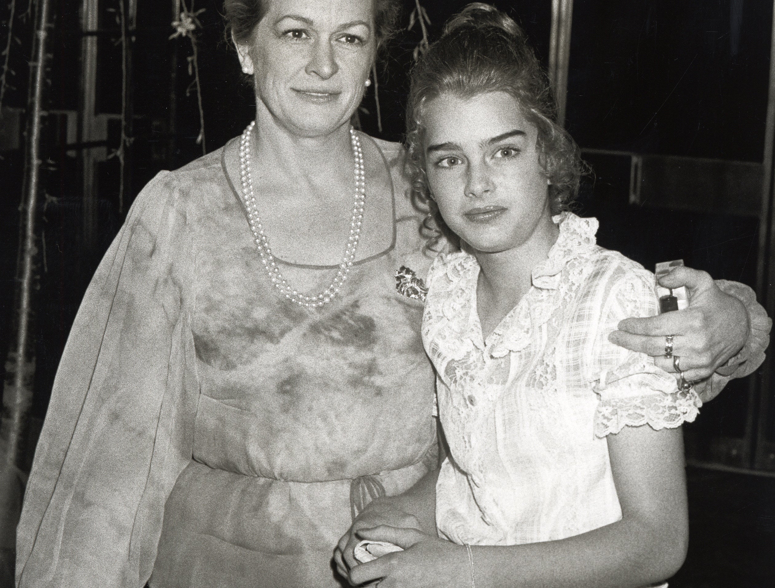 Brooke looks uncertain while posing for a photo with her mom as a teen