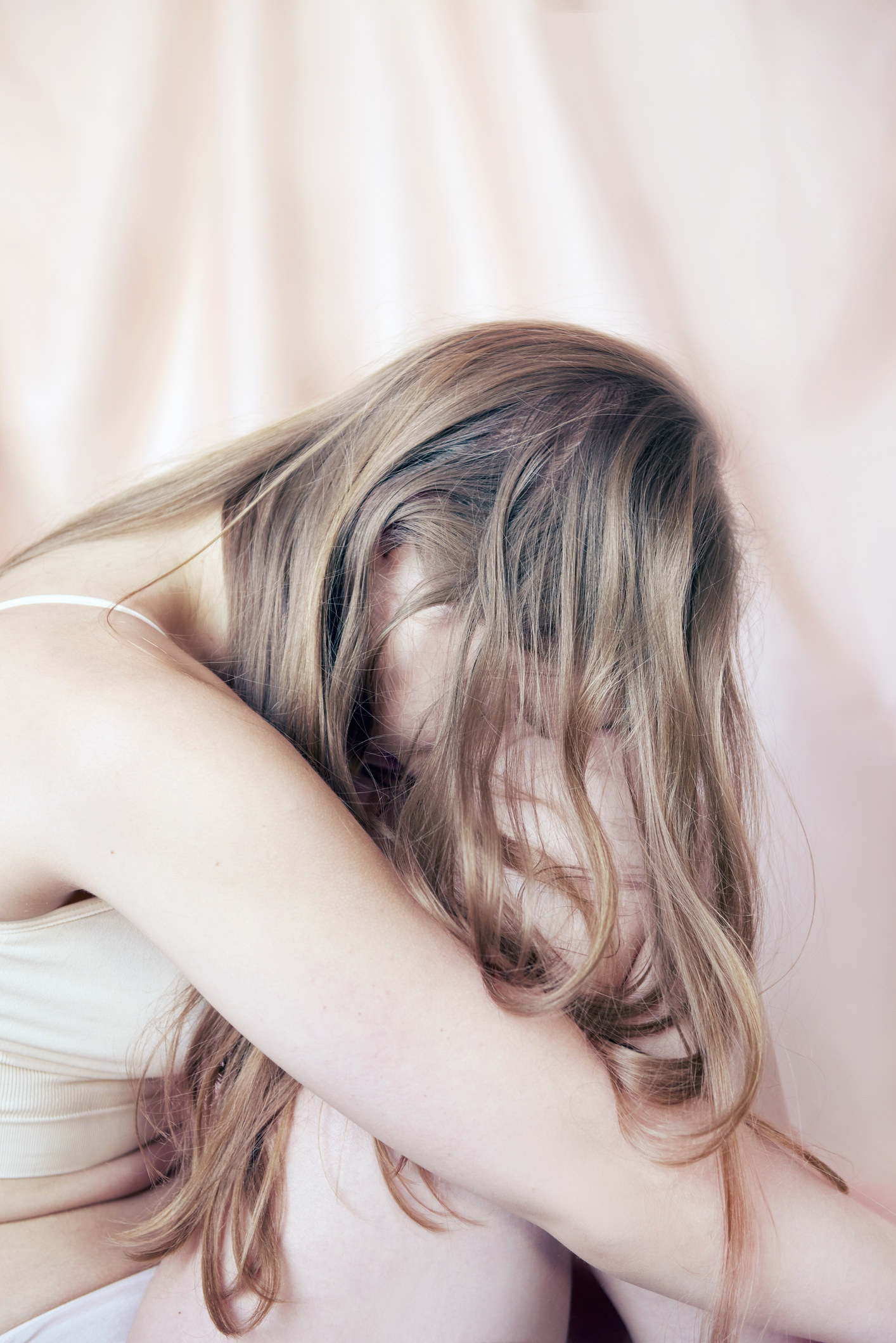 woman crying with her head in her knees