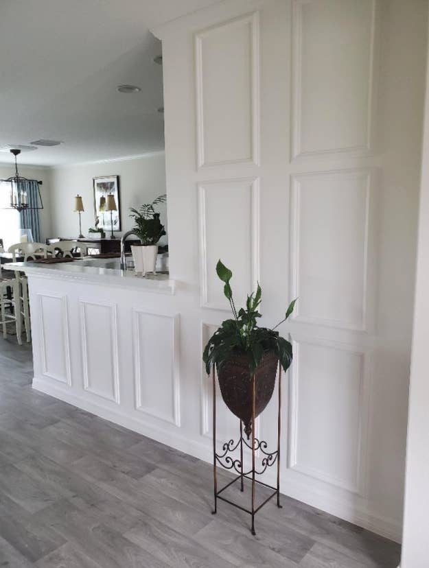 reviewer's wall with panels installed and painted white to add depth to wall