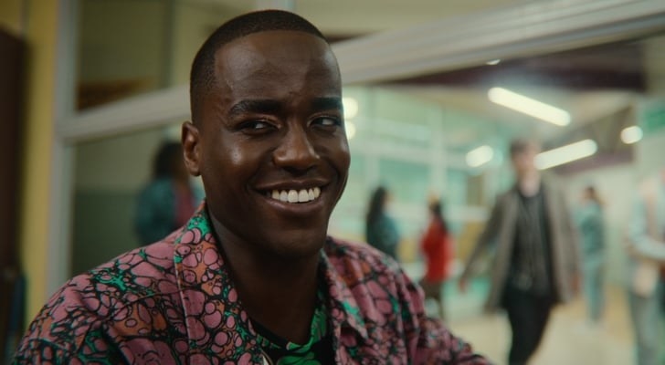 Ncuti Gatwa as &quot;Eric&quot; is looking off to the side smiling in Sex Education