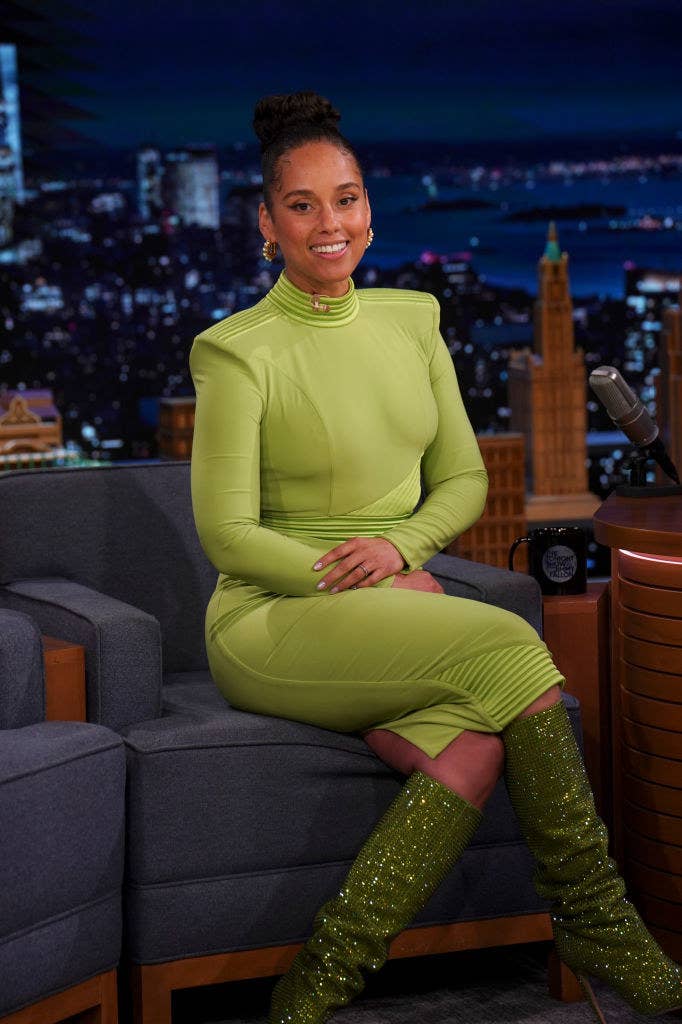 Alicia Keys sitting in a chair while on a late night talk show