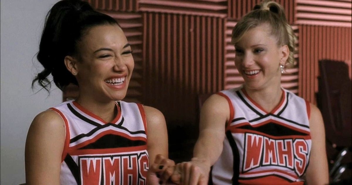 Naya Rivera as &quot;Santana&quot; and Heather Morris as &quot;Brittany&quot; laughing together in their cheerleading uniforms