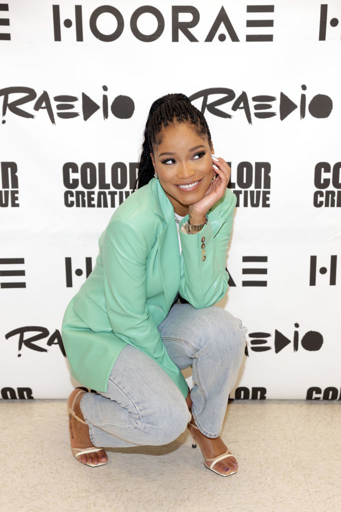 Keke crouching down for a photo at an event