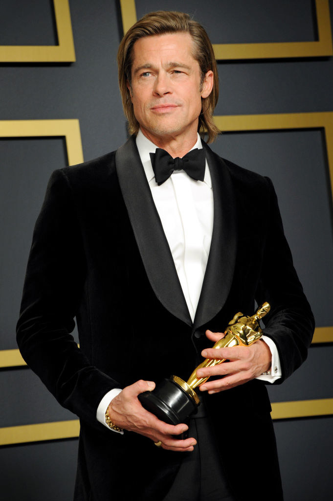 Brad holding an award on the red carpet