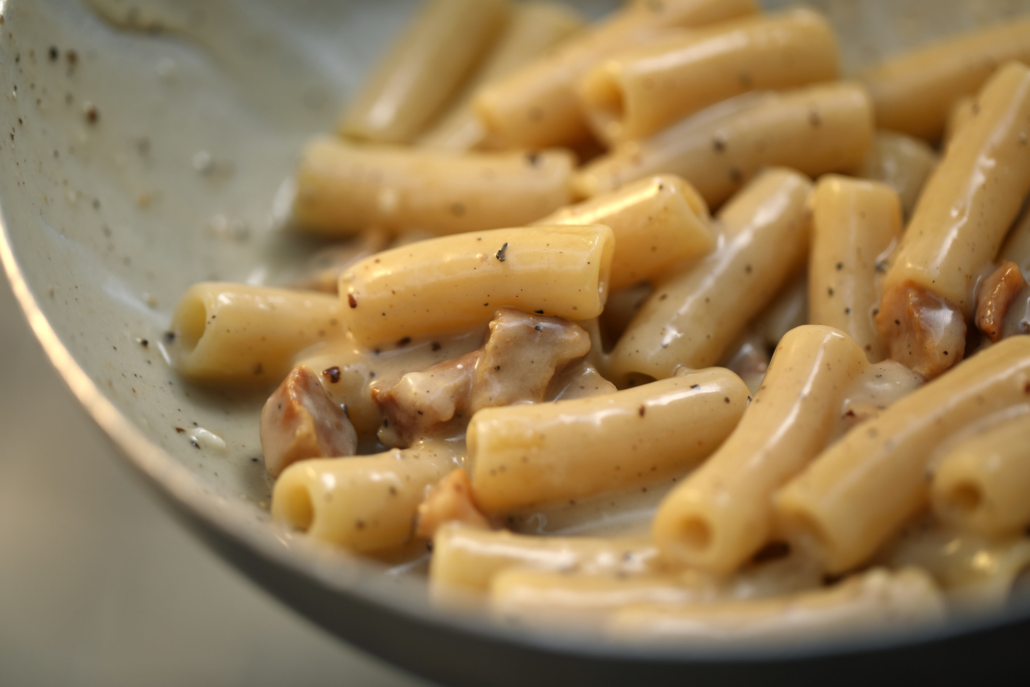 Pasta sauce with cracked black pepper.