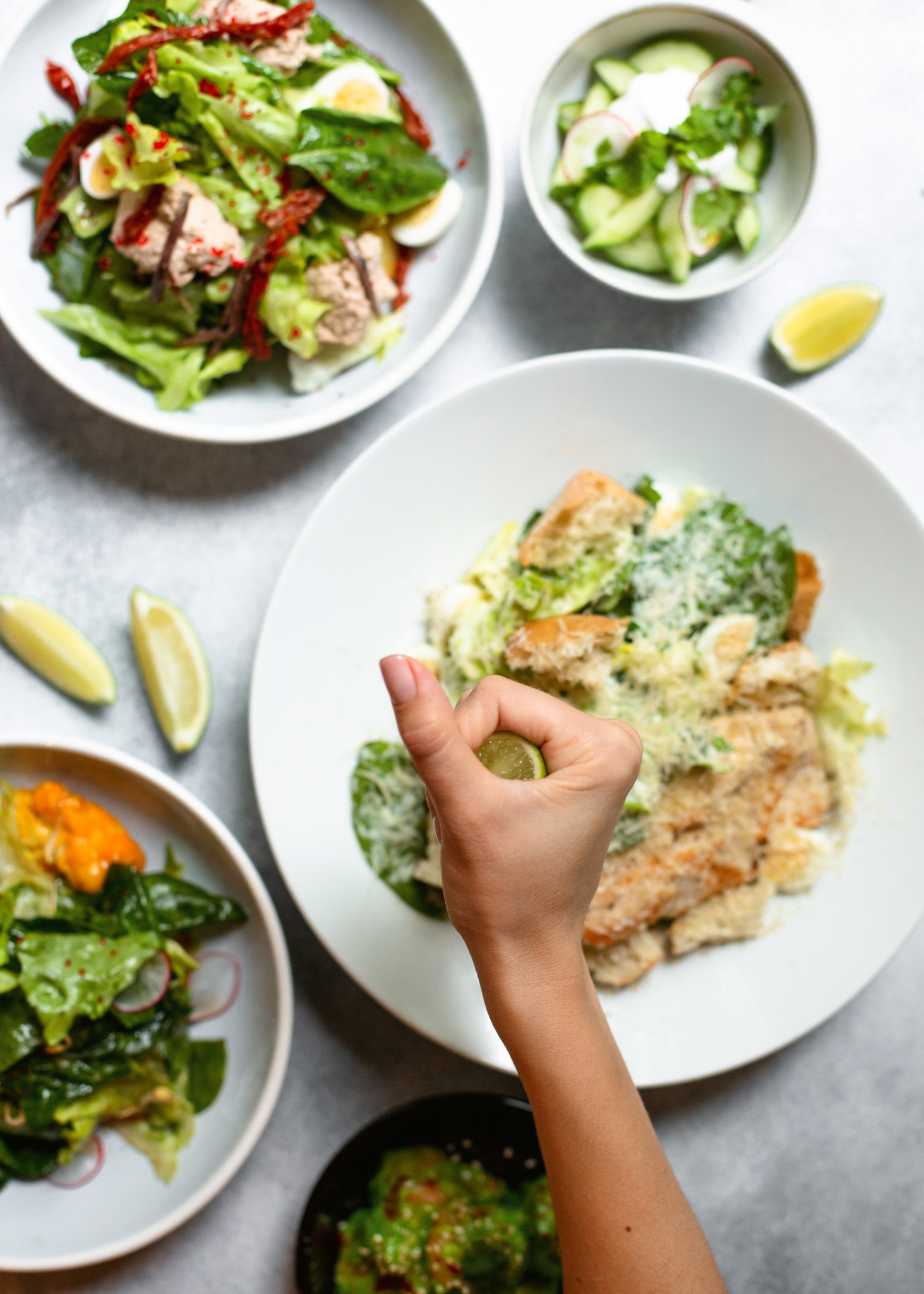 Squeezing lemon juice to salad with chicken breast.