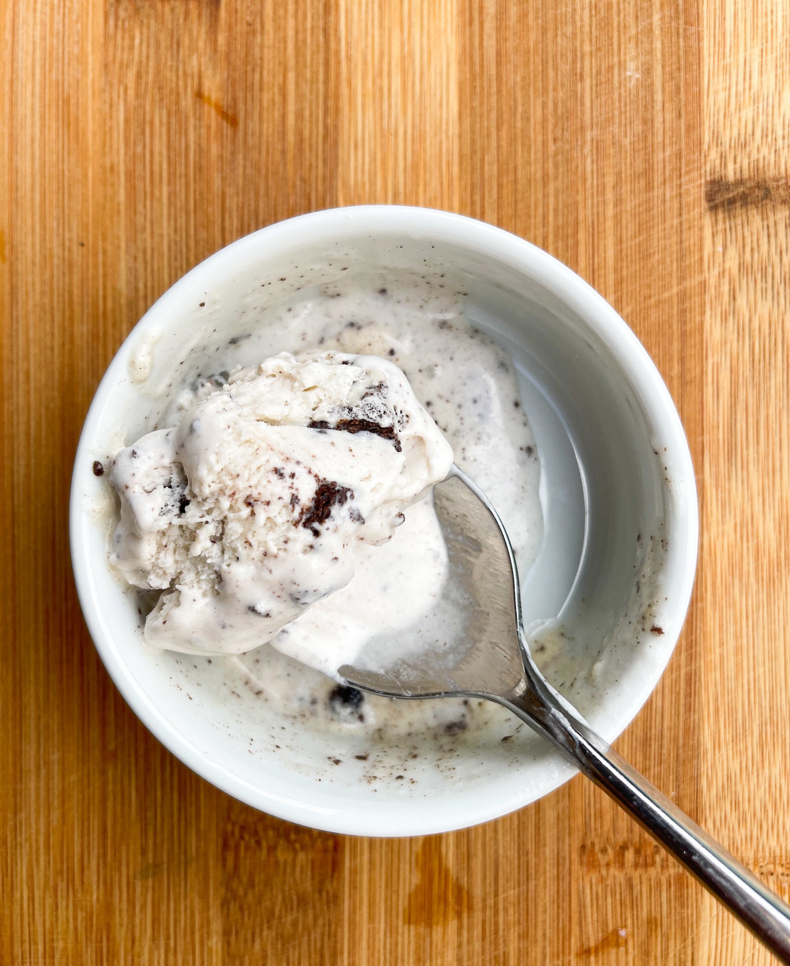 A pint of ice cream with a spoon in it