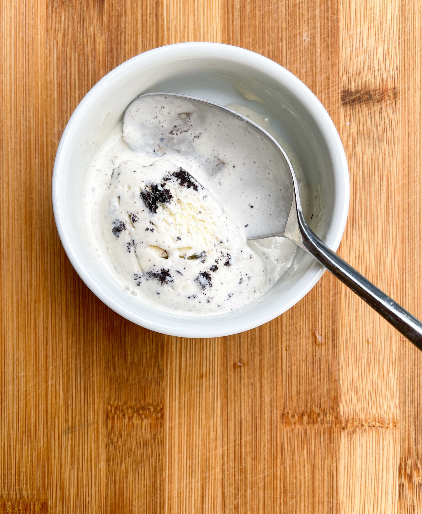 A pint of ice cream with a spoon in it