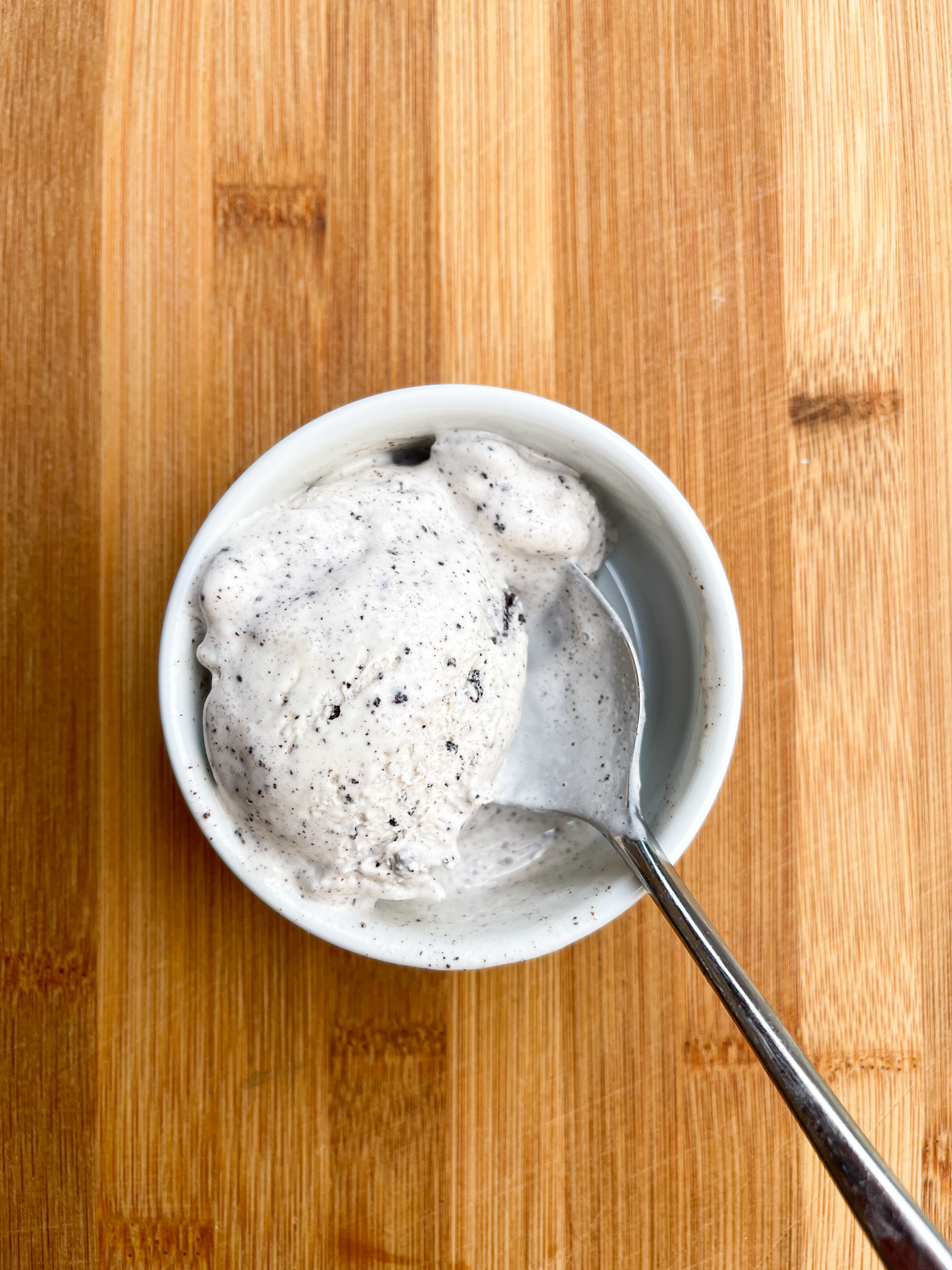 A pint of ice cream with a spoon in it