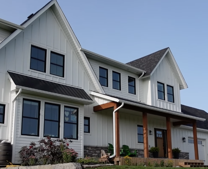 The exterior of a white farmhouse–style house