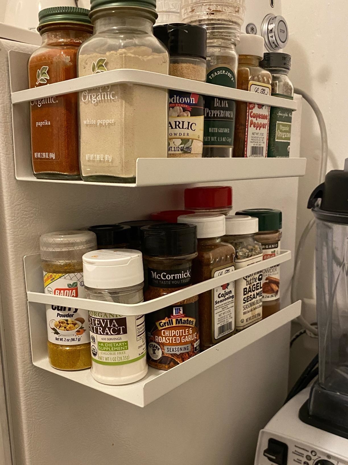 Reviewer&#x27;s magnetic shelf is shown attached to a fridge