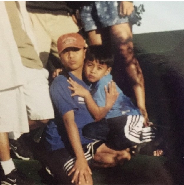 Two young boys hugging and pursing their lips slightly