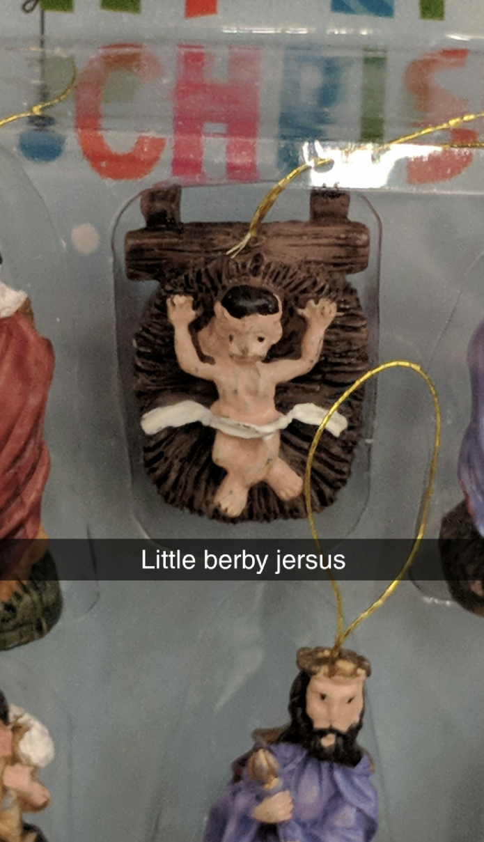 &quot;Little berby jersus&quot; caption with a misshapen doll Jesus with arms raised