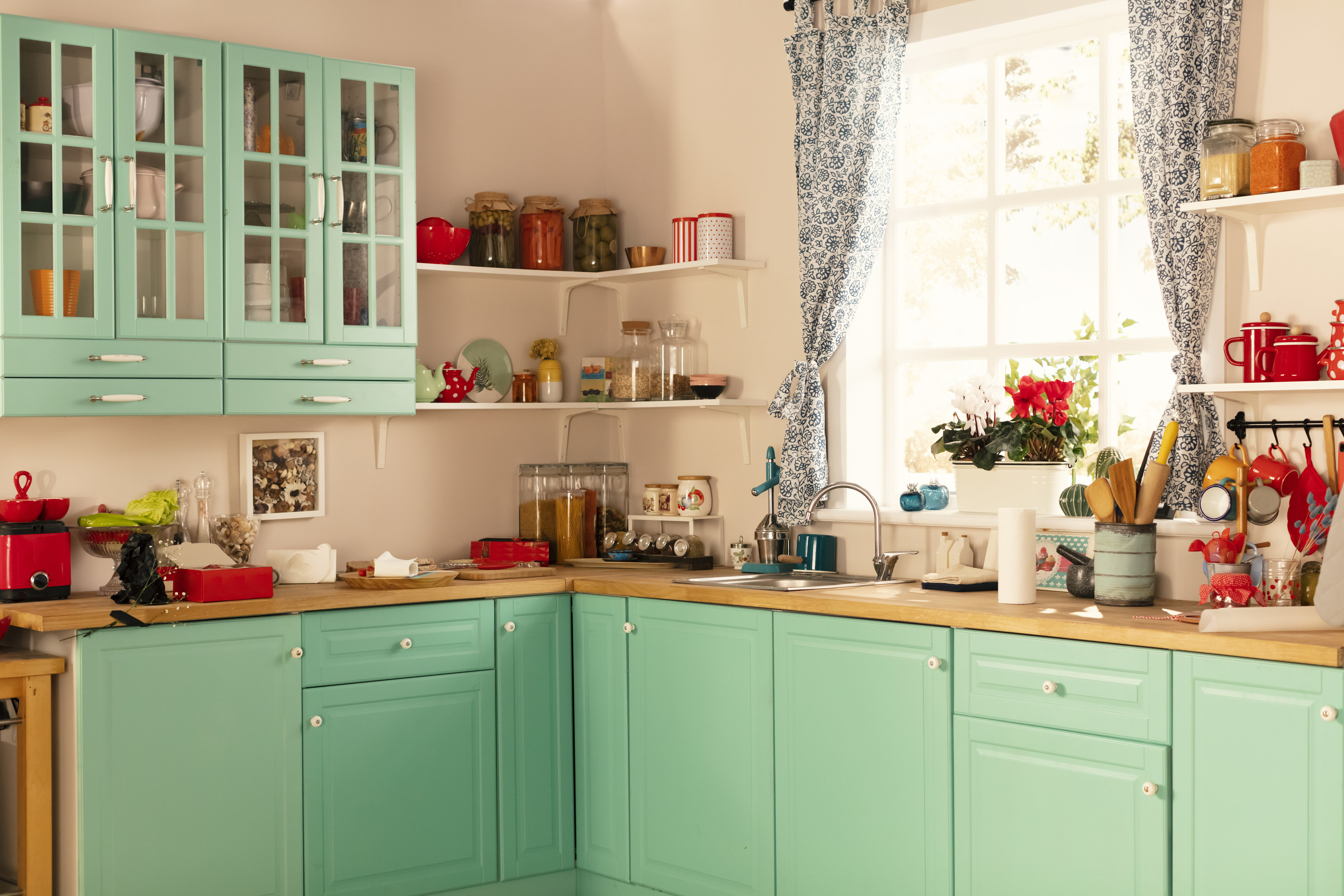 seafoam green retro kitchen cabinets with butcher block counters