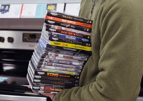 Someone holding a stack of DVDs