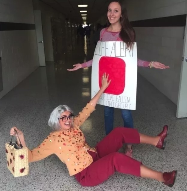 one girl dressed as an old lady and one girl dressed as a &quot;Life Alert&quot; button