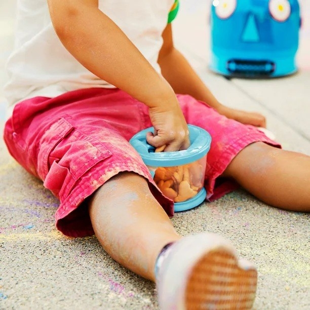 Child uses snack container