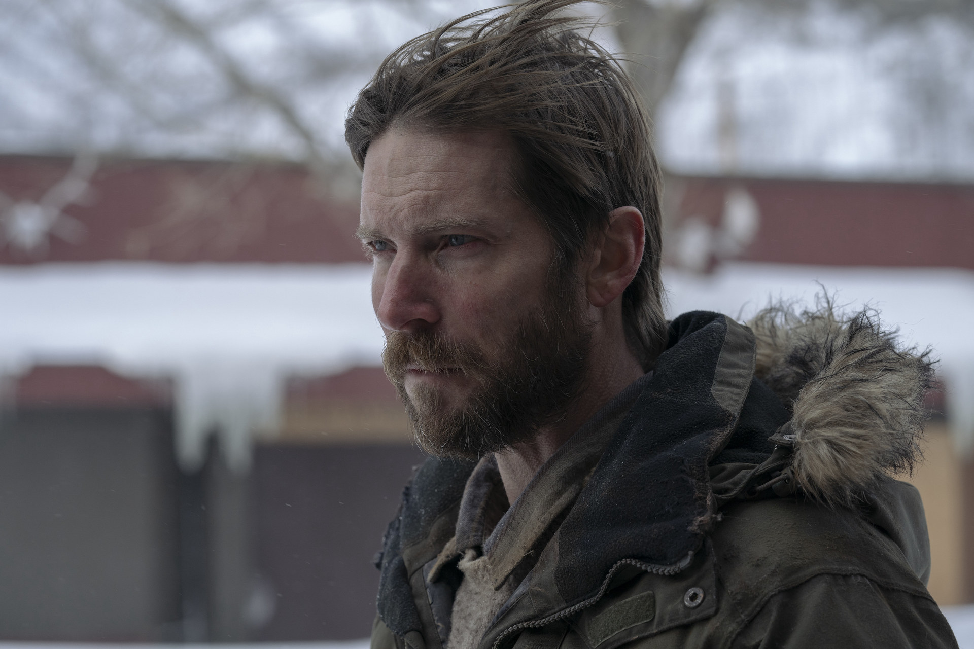 Troy Baker in an army green winter coat