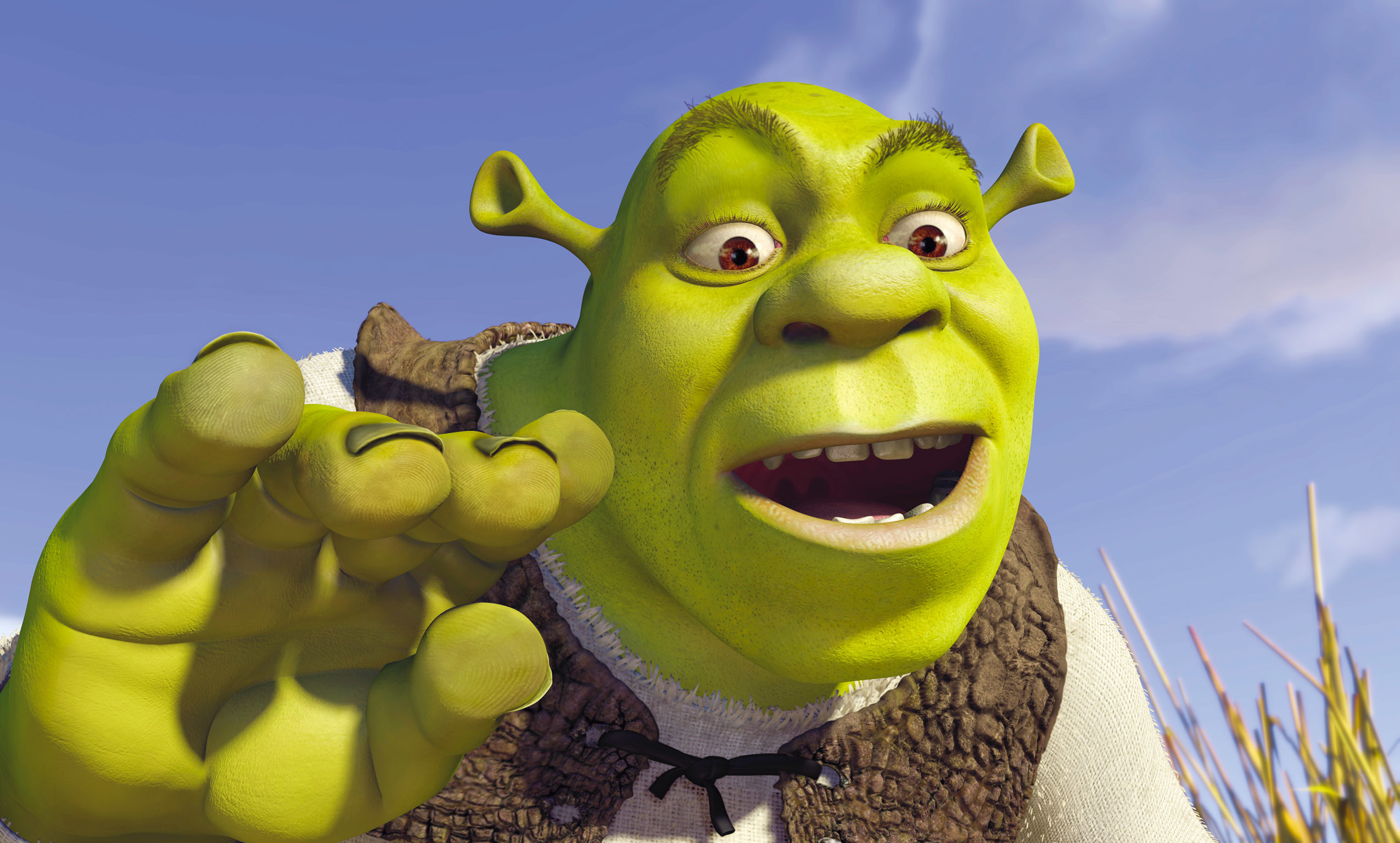 Shrek, an animated ogre character, with a surprised expression, raising his hand in front of an outdoor background