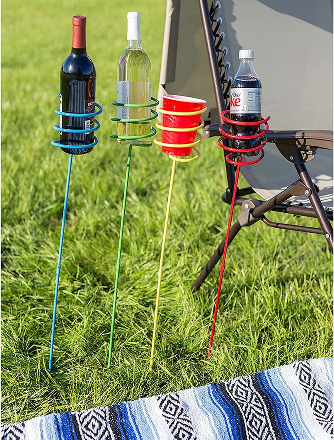 Four metal drink holders are in the grass