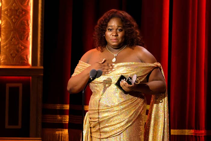 Alex accepting their Tony award on stage