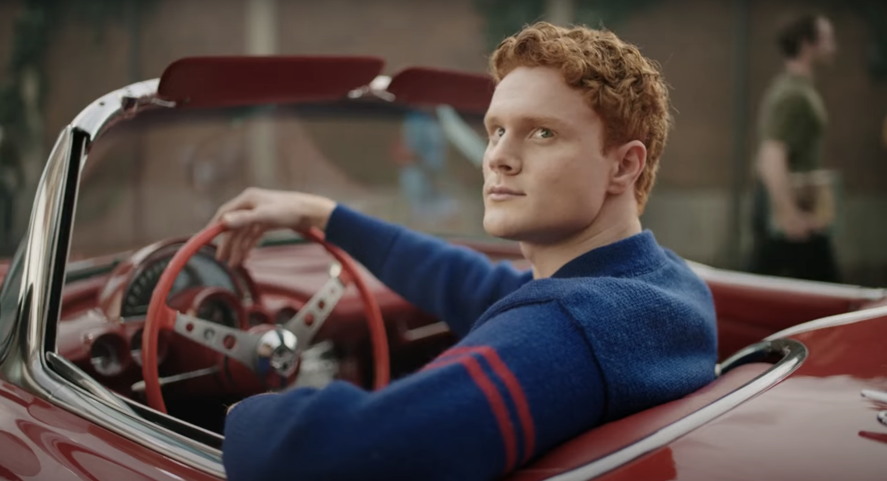 Young man sitting in the driver&#x27;s seat of a sports convertible