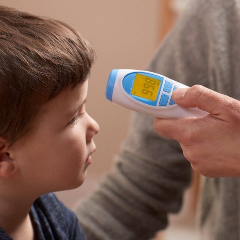 Child model gets temperature read with a thermometer