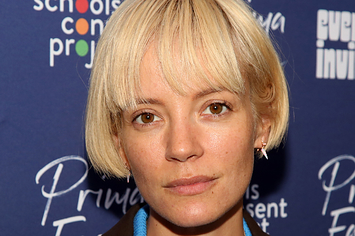 Lily Allen poses for a photo with her head titled