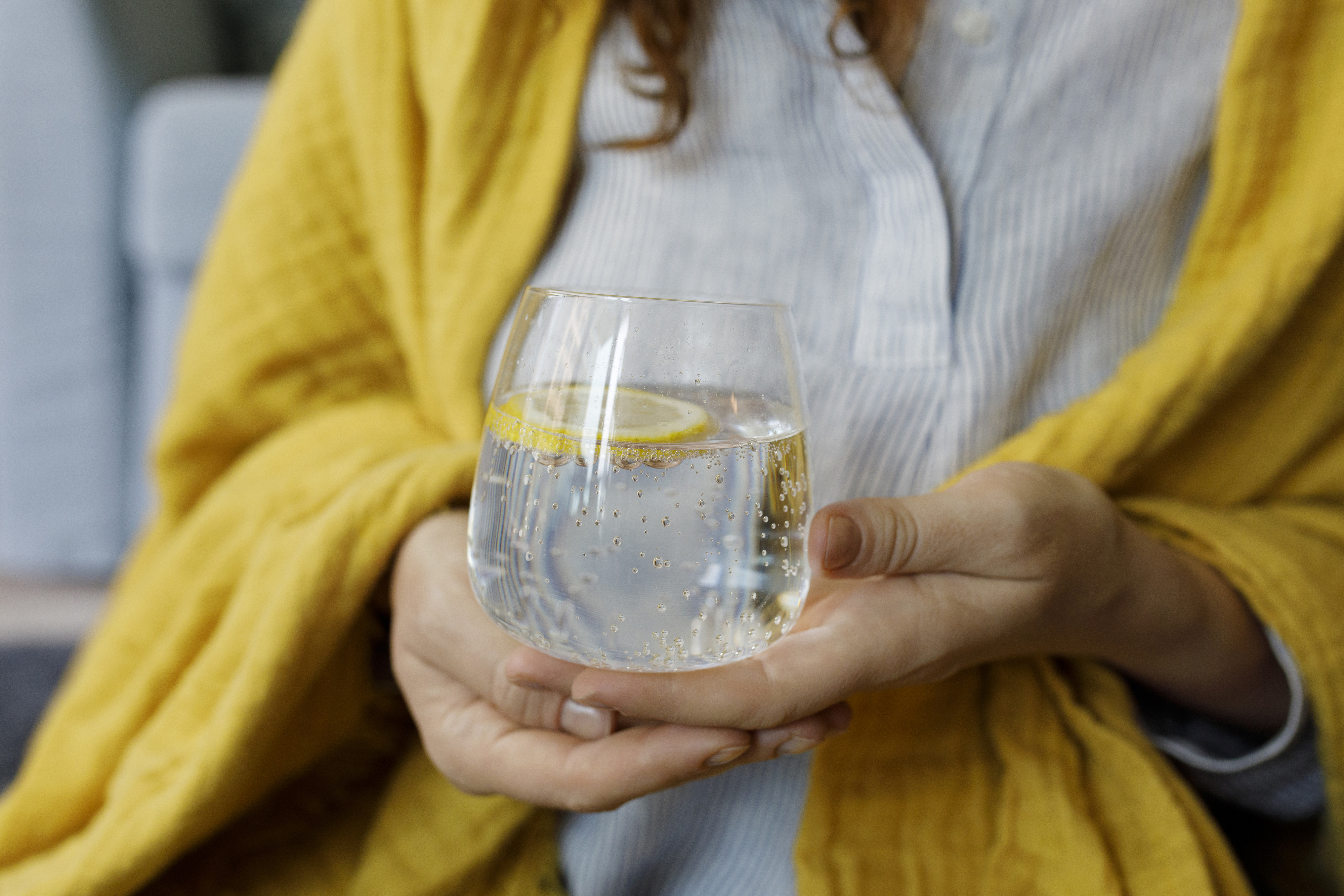 a woman holding a glass of water