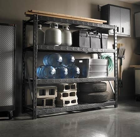 A large steel shelves with heavy items resting on it in a garage