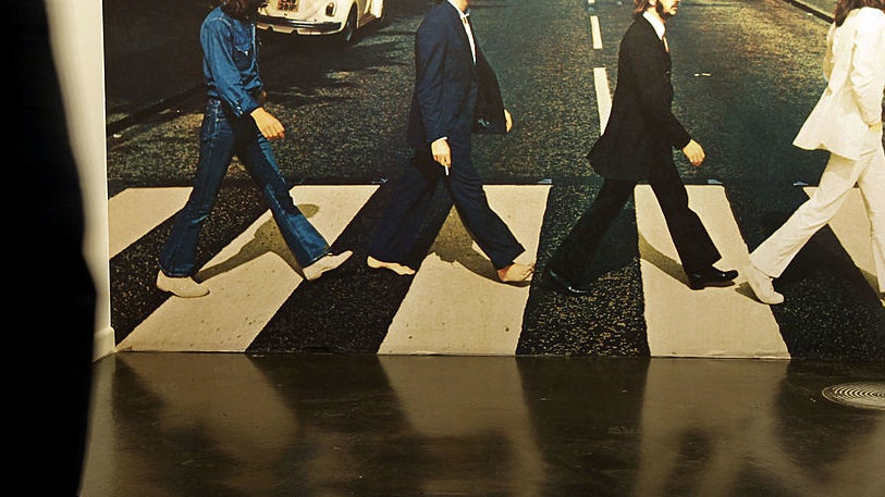 the members walking across the street in their album cover