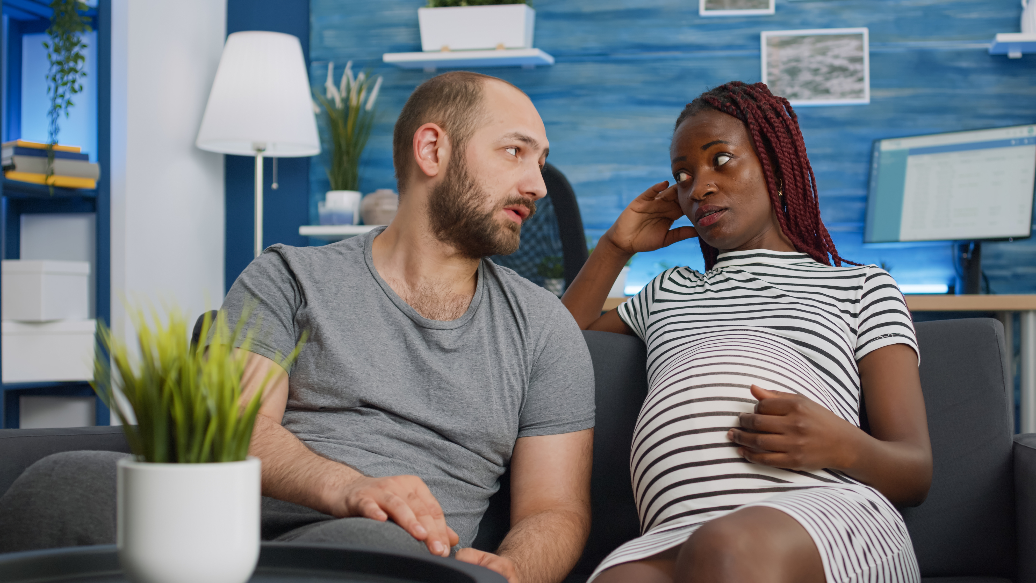 couple having an argument on the couch