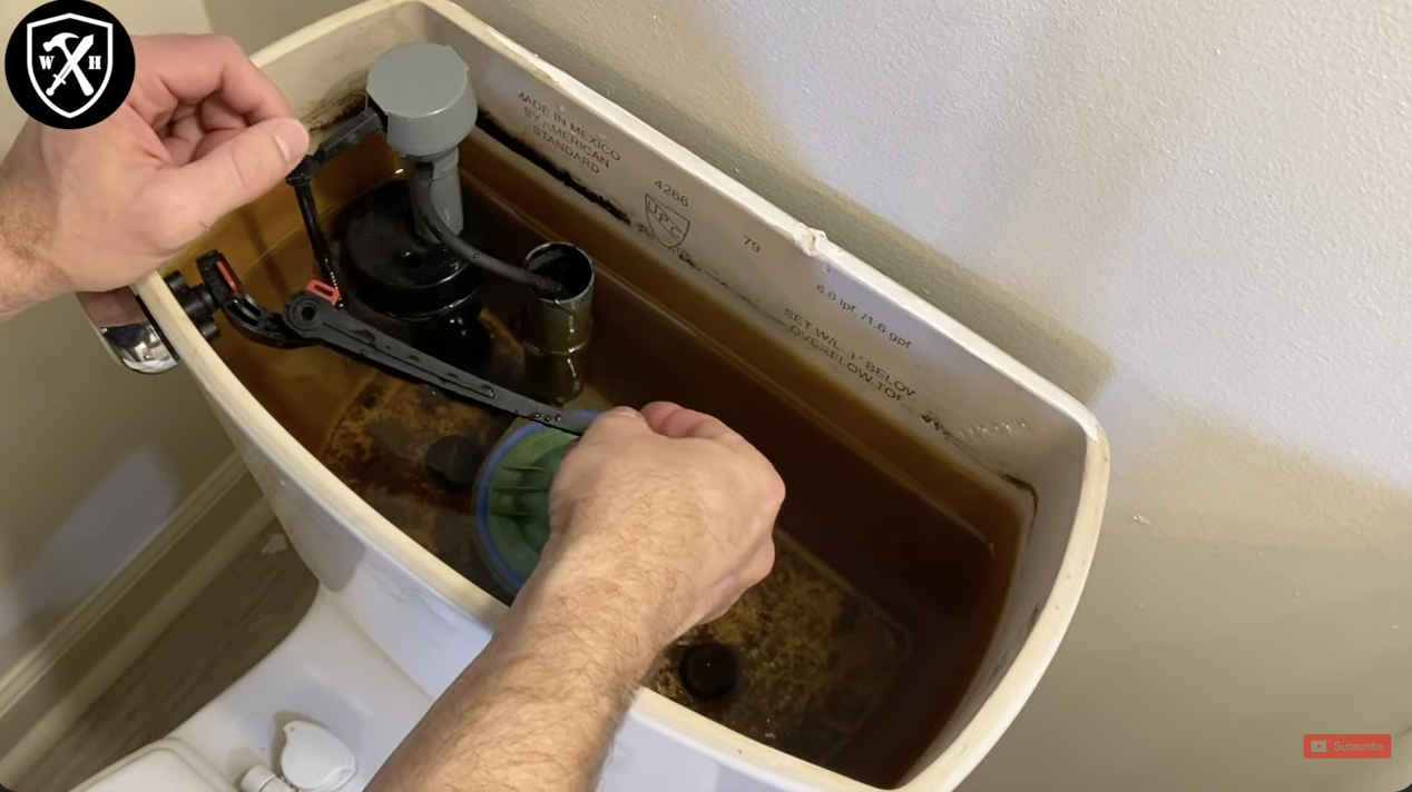 A person fixing their toilet