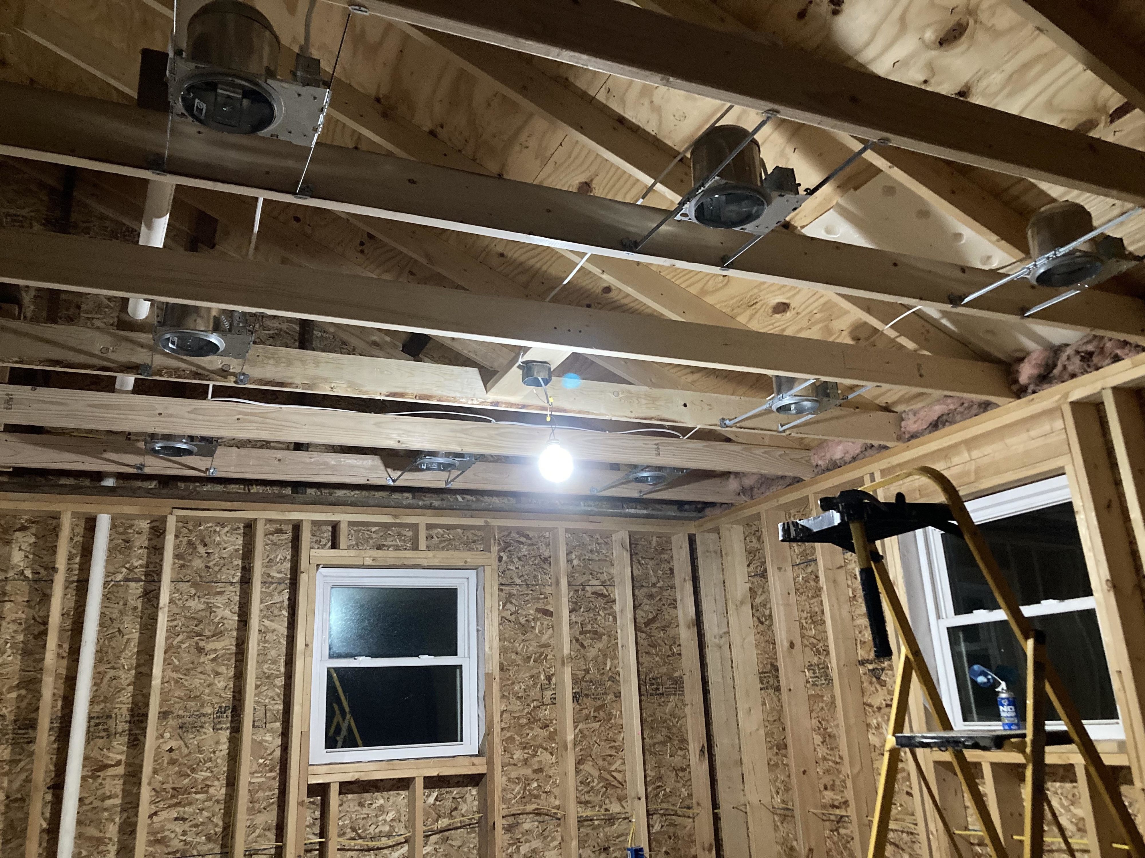 nine different recessed pot lights in one room down to the wood studs