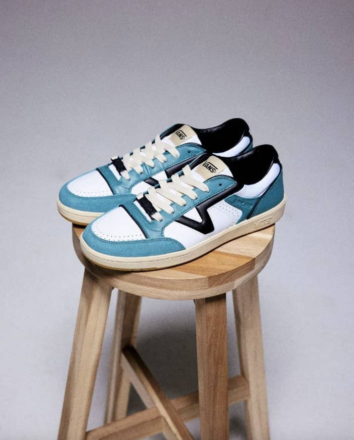 A pair of sneakers displayed on a wooden stool