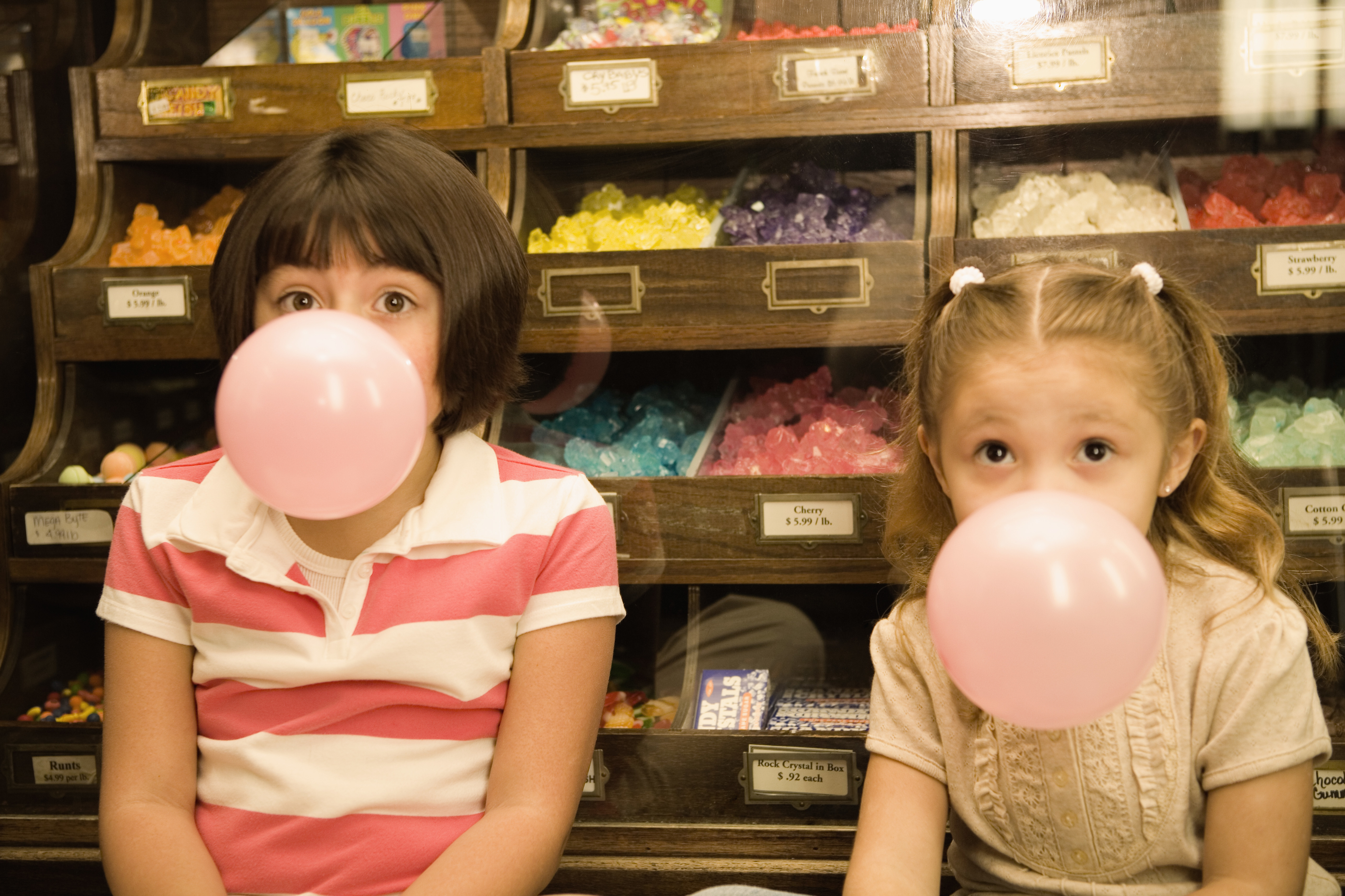 two kids blowing gum