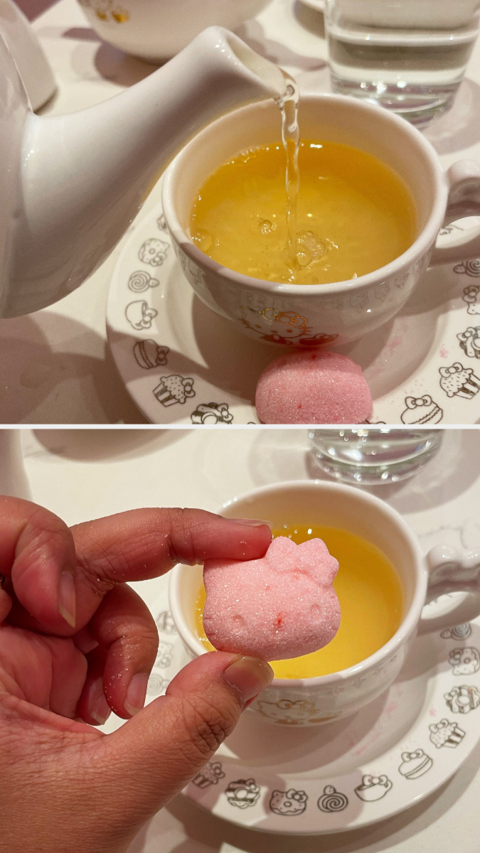 The author is pouring tea and is showing a Hello Kitty–shaped sugar cube