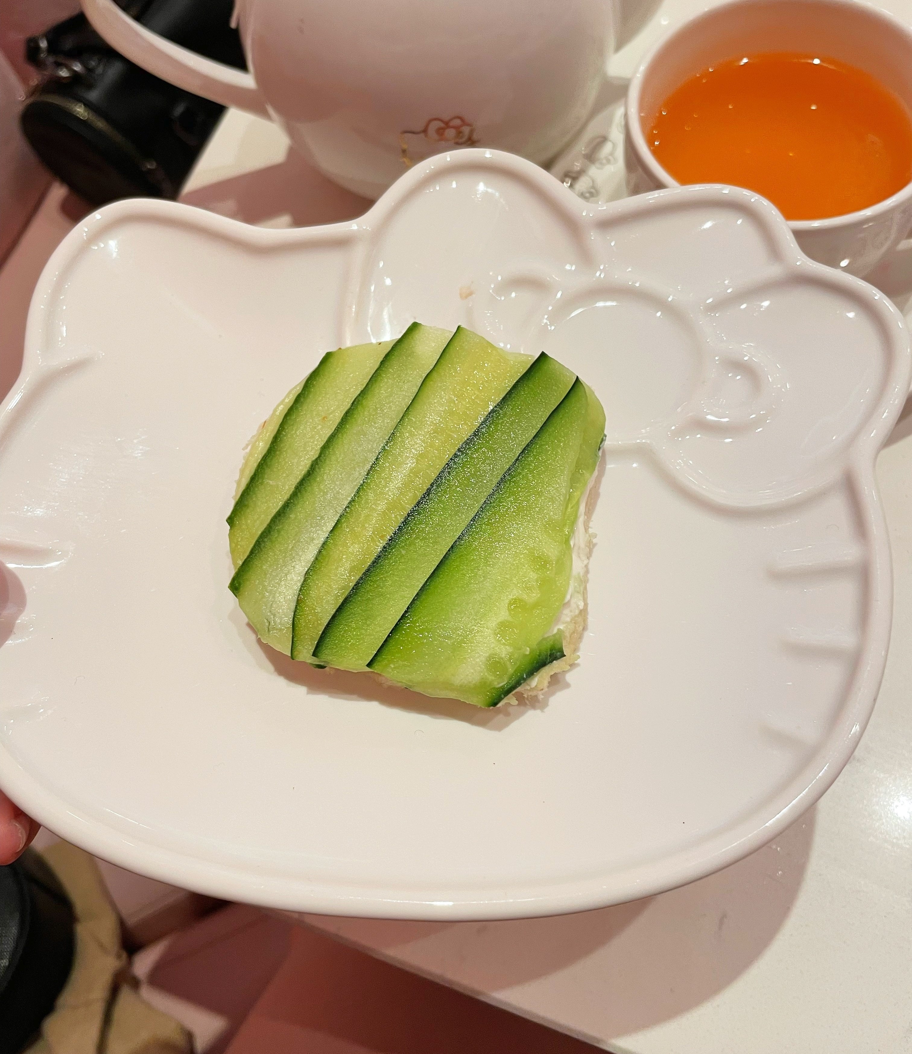 A cucumber sandwich is on a plate