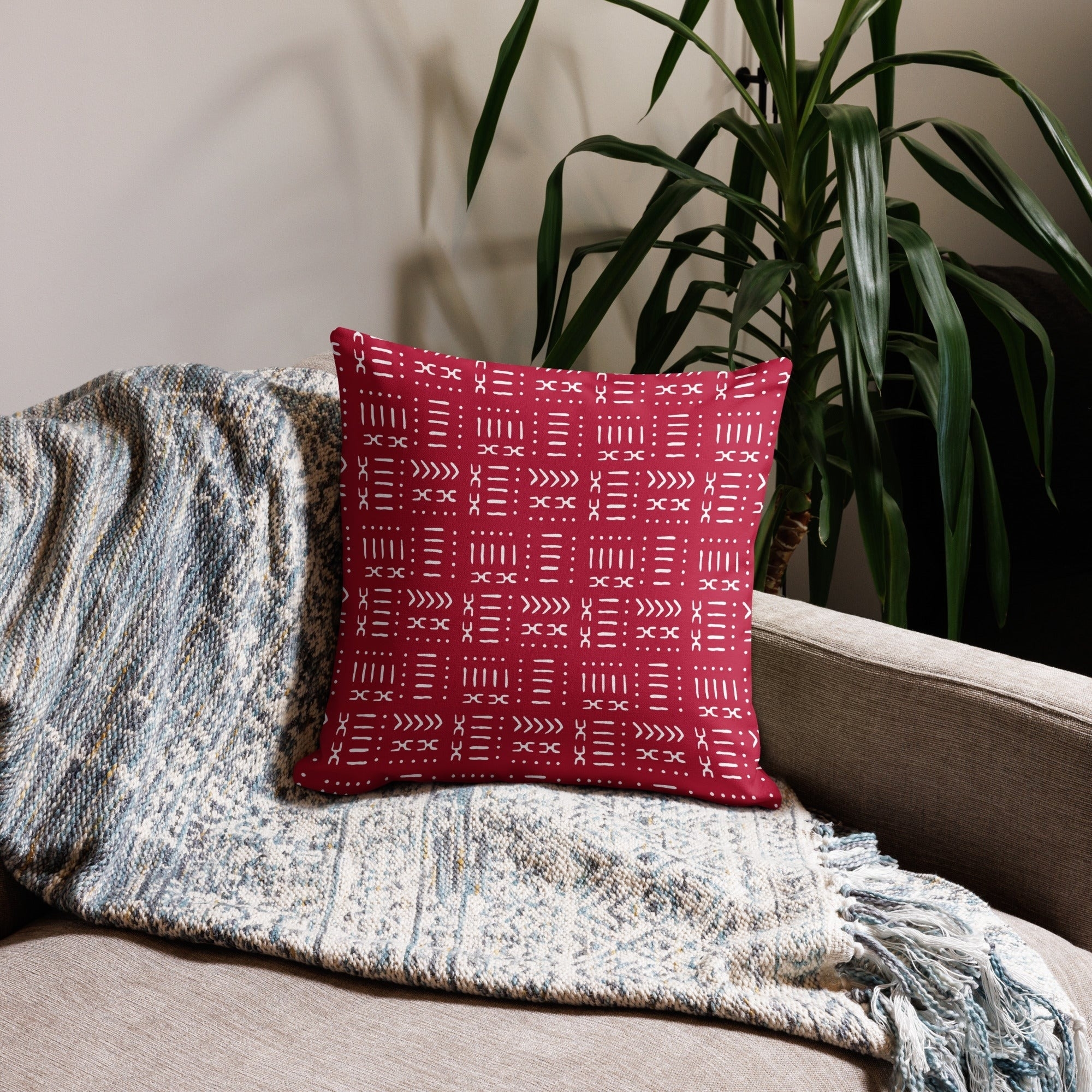 A red and white pillow on a sofa