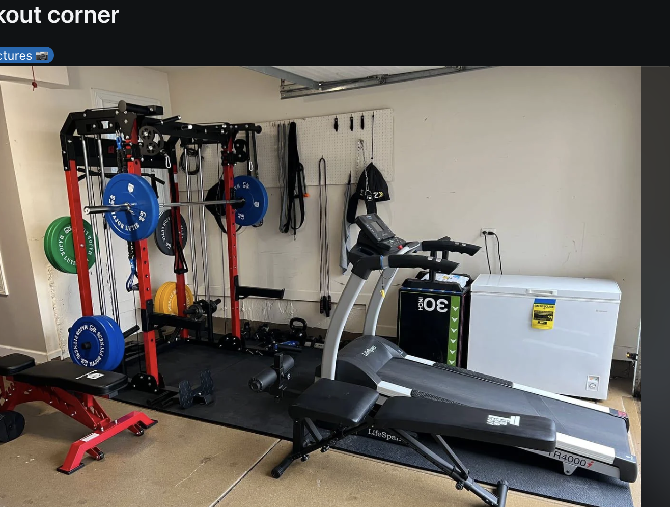 Home gym setup with various exercise equipment including a treadmill, weights, and bench