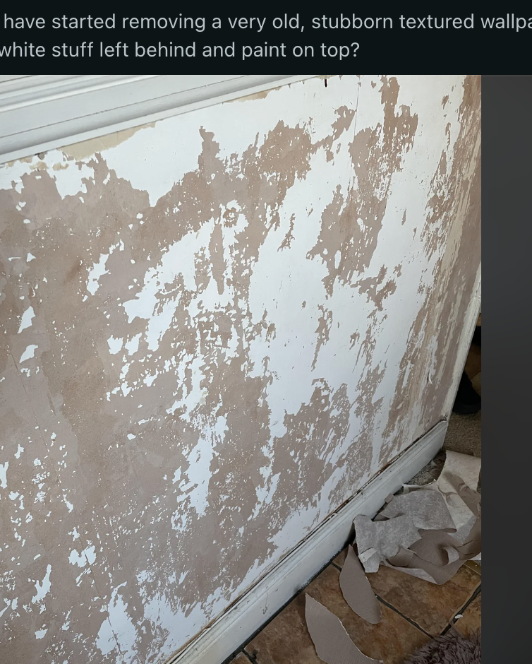 Textured wallpaper removal process is being shown inside a home