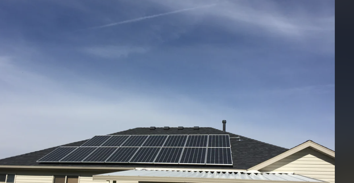 Roof with installed solar panels against a clear sky