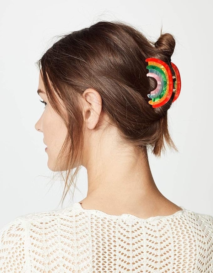 Woman with a unique circular rainbow hair accessory in her bun, viewed from behind