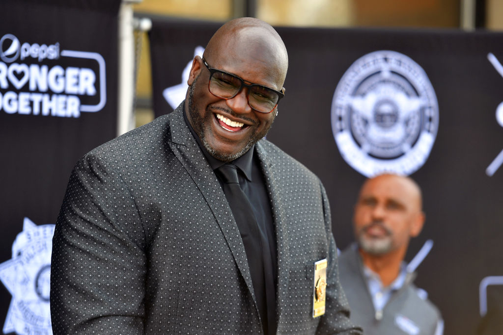 Smiling man in a dotted suit at an event; cannot name individuals in the image