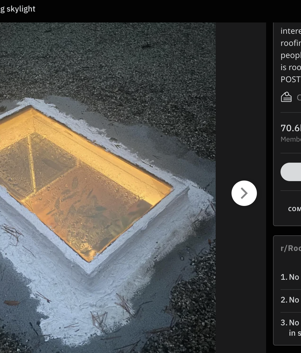 A lit-up empty pool at dusk with a house&#x27;s reflection