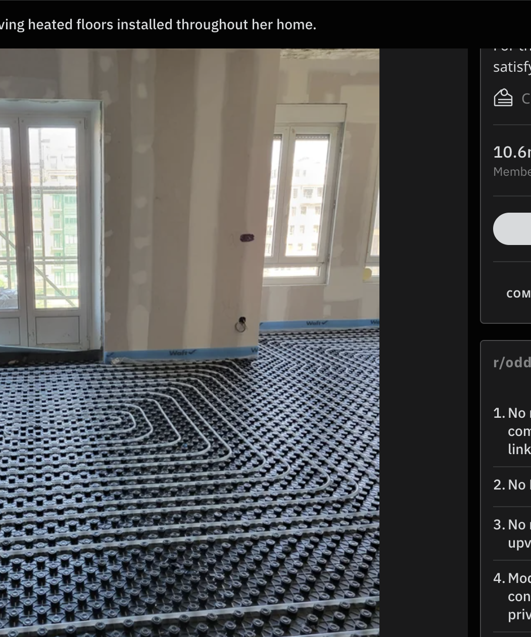 Intricate black floor tubing for underfloor heating installation in an unfurnished room with large windows and bare walls