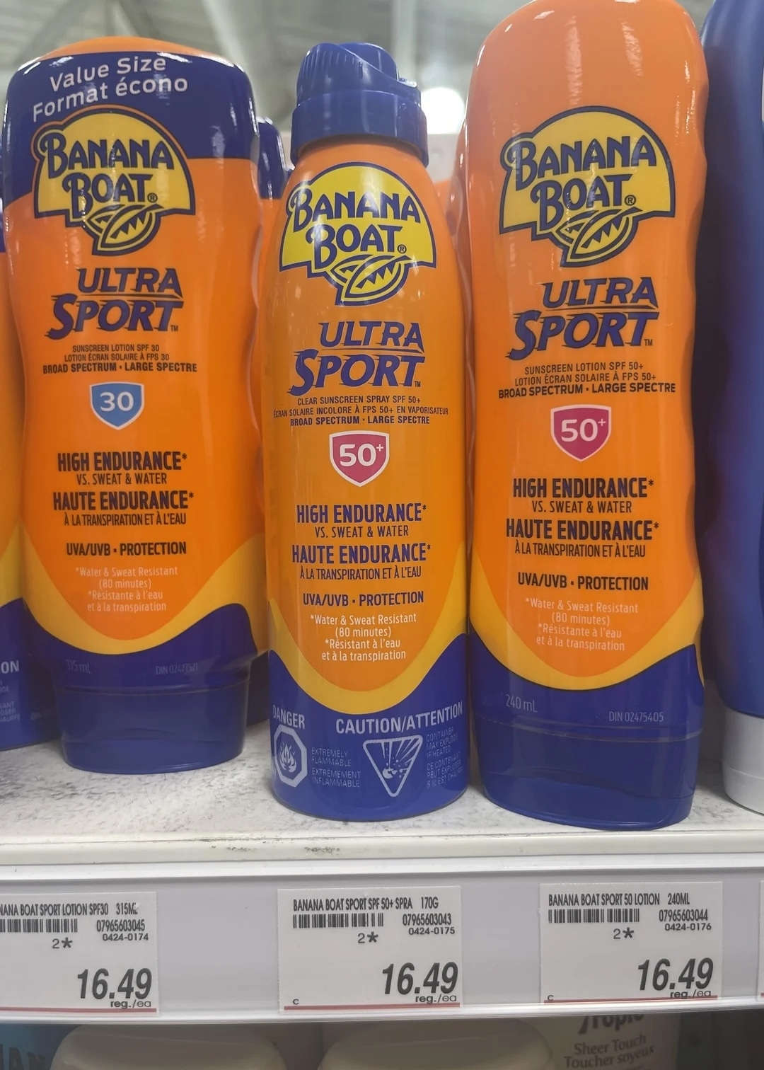 Banana Boat Ultra Sport sunscreen bottles on a store shelf, labeled SPF 50, priced at $16.49