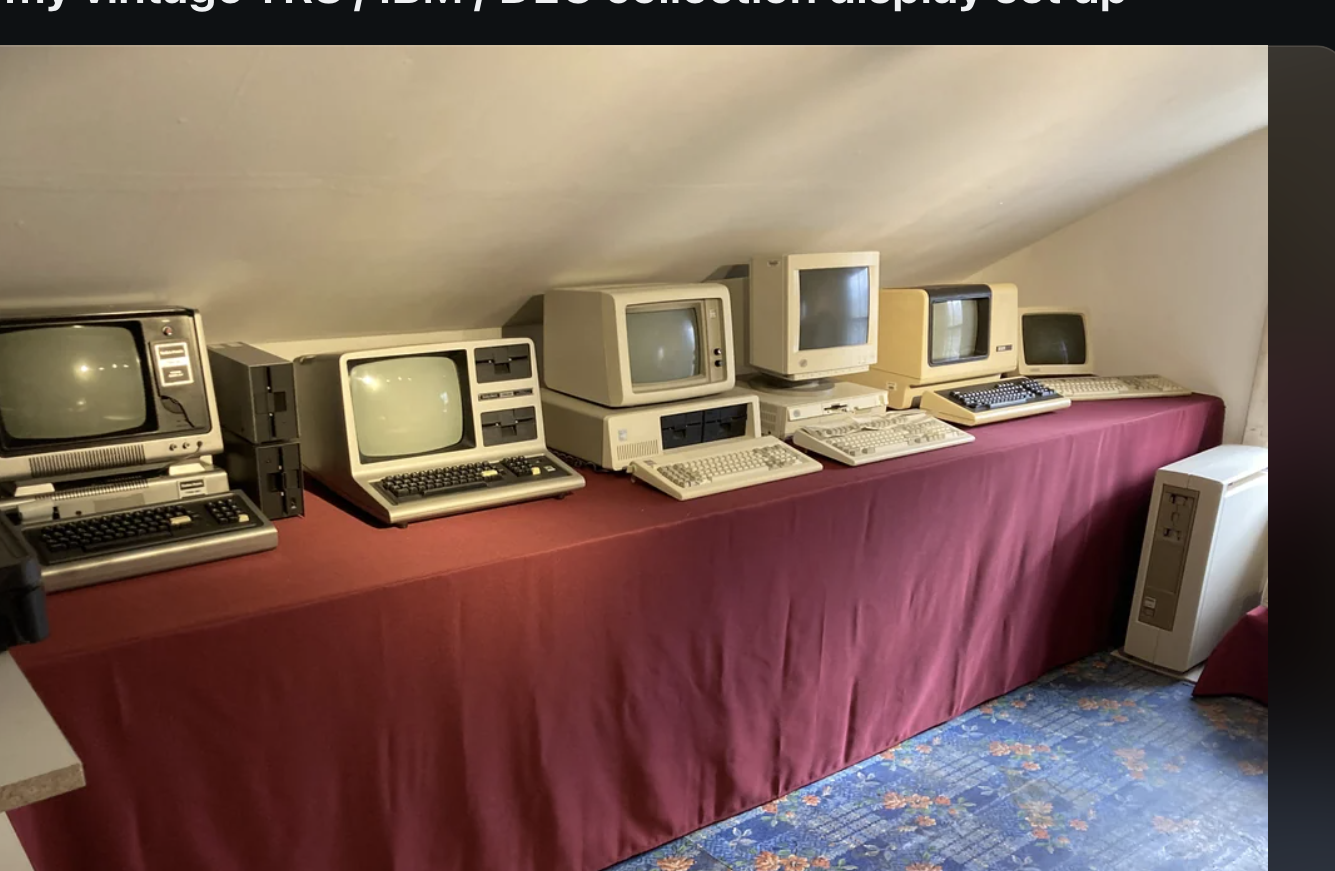 Vintage computer setup with multiple old monitors and CPUs on tables in a room