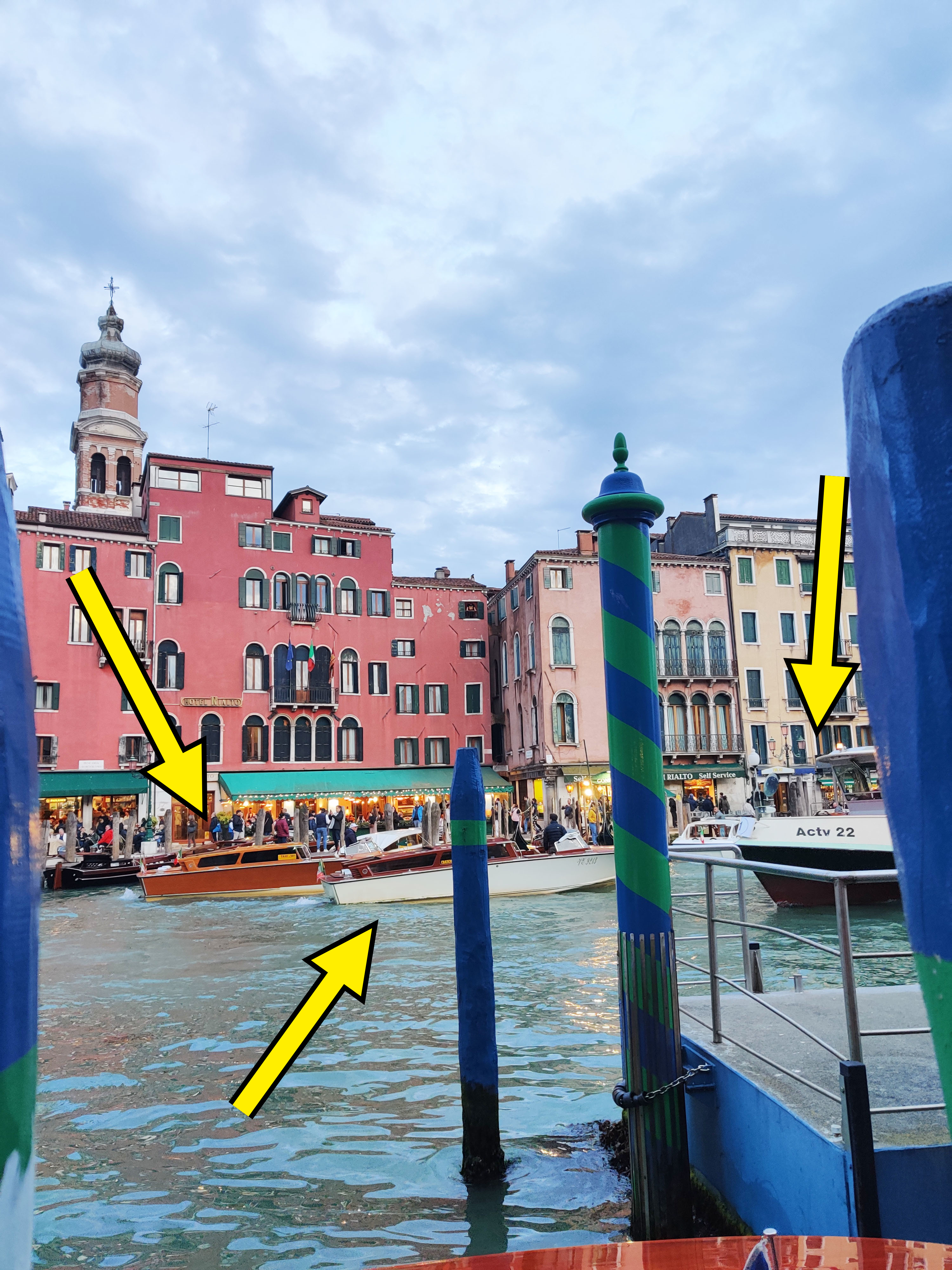 View of Venice canal with mooring poles and buildings, capturing the essence of travel in Italy